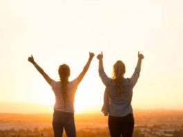 Two women with hands raised, happy with their achievement - 11 Simple Ways to Be Your Very Best