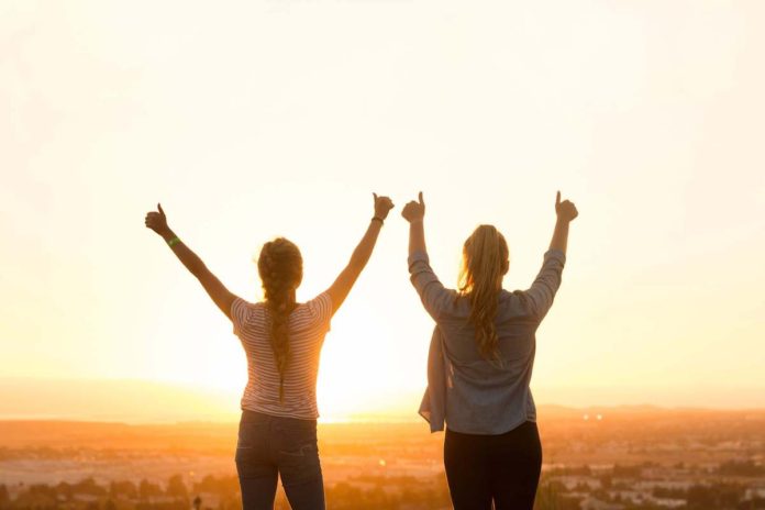 11 Simple Ways To Be Your Very Best - Feature Two women with hands raised, happy with their achievement - 11 Simple Ways to Be Your Very Best