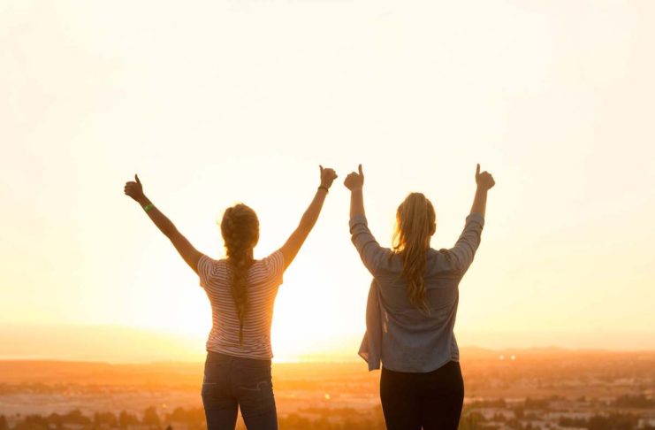 Revealed: 11 Simple Ways to Be Your Very Best Two women with hands raised, happy with their achievement - 11 Simple Ways to Be Your Very Best