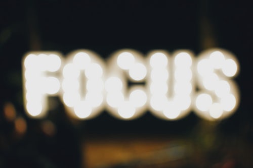 Image with blurred capital letters "FOCUS" that just mean "lack" of focus