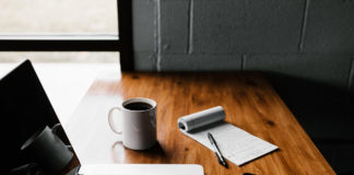 Laptop, coffee cup, notepad and phone on an oak desk - Best 3 Simple Ways To Monetize Your Blog