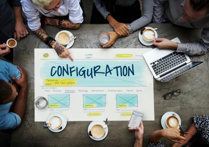 Overhead view of employees around a Configuration design chart - setting up WordPress