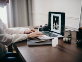 Image of woman's hands on a laptop editing an image - how to optimize images without losing quality