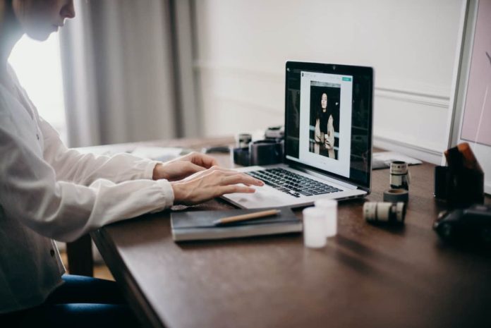 How To Optimize Images Without Losing Their Quality - Feature Image of woman's hands on a laptop editing an image - how to optimize images without losing quality