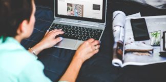 image over the shoulder of a woman blogging