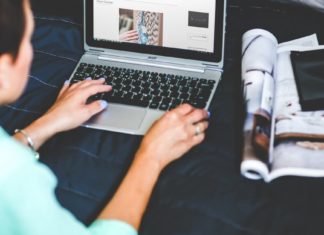 image over the shoulder of a woman blogging