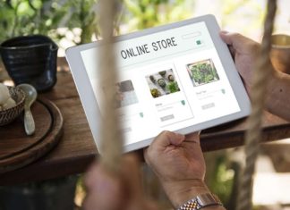 Image of man holding tablet with "Online Store" on it