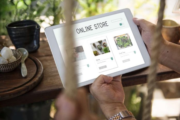 Image of man holding tablet with "Online Store" on it