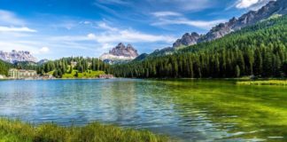 Gorgeous stock photo of river bordered by a mountain chain