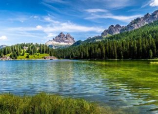 Gorgeous stock photo of river bordered by a mountain chain